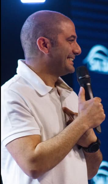 Pastor Dorian Sarkissian speaking with a microphone.